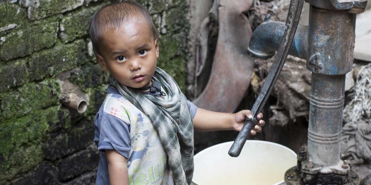 71. a child at a water pump in mandanpur khadar  delhi